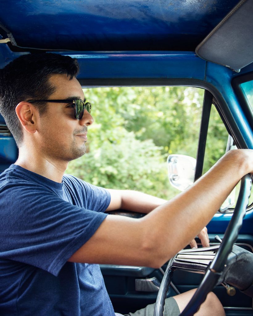 man-in-sunglasses-driving-pick-up-truck-2022-03-09-02-27-31-utc